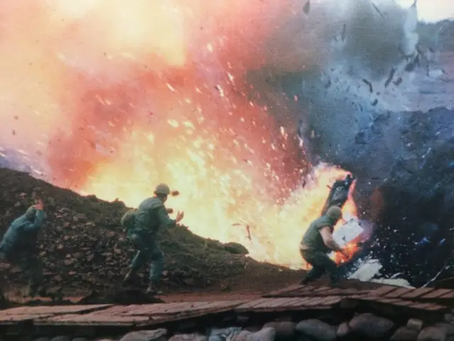 Picture By Robert J. Ellison. Ammunition Dump Struck By A Shell Fired From A North Vietnamese Position Explodes Infront Of U.s. Marines